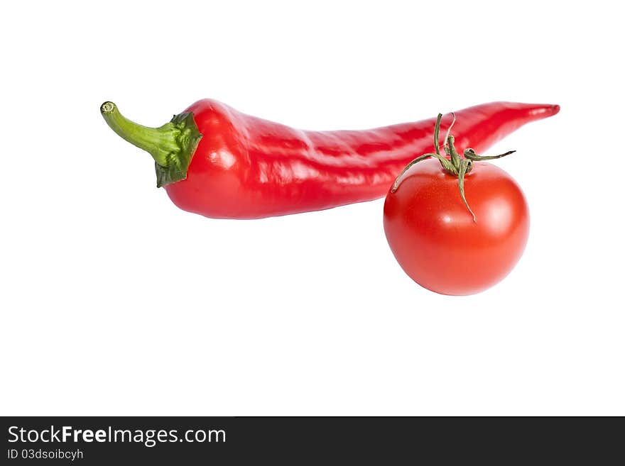 Tomato and red hot chili peppers isolated on white background