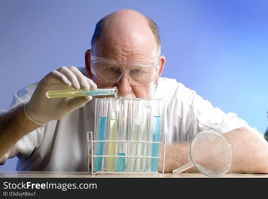 Scientist working with chemicals on blue background