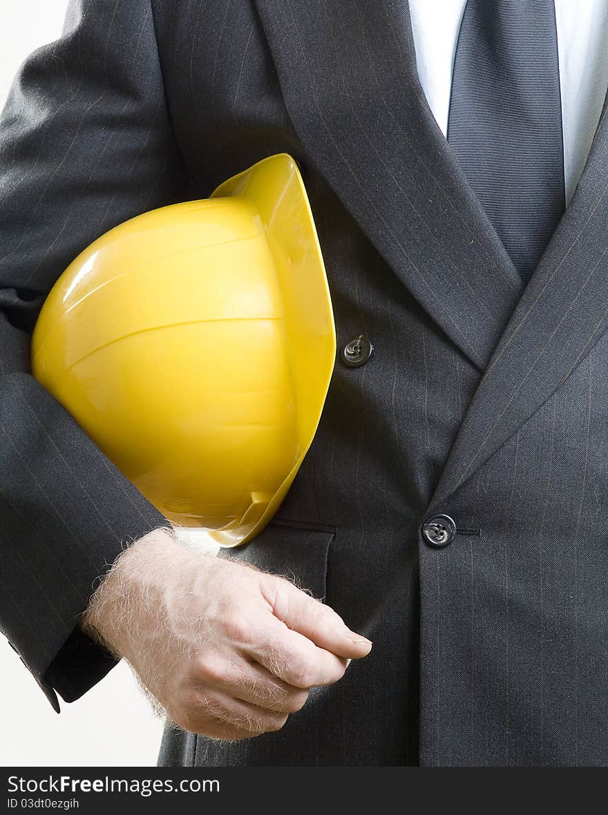 Yellow construction hat under arms