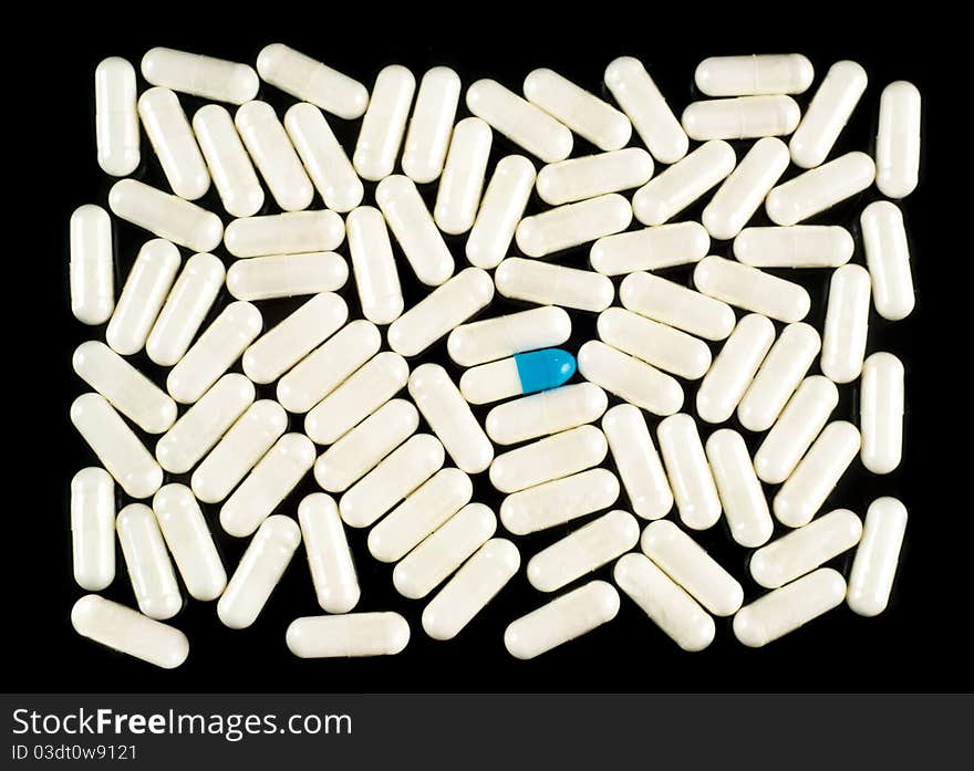 Pills (capsules) on black background