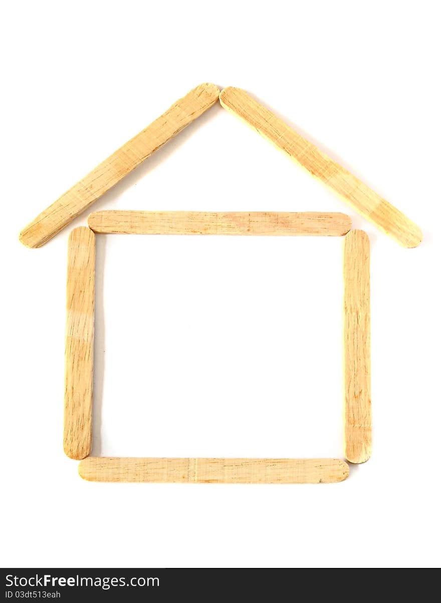 Wood ice-cream stick in shape as a house on white background