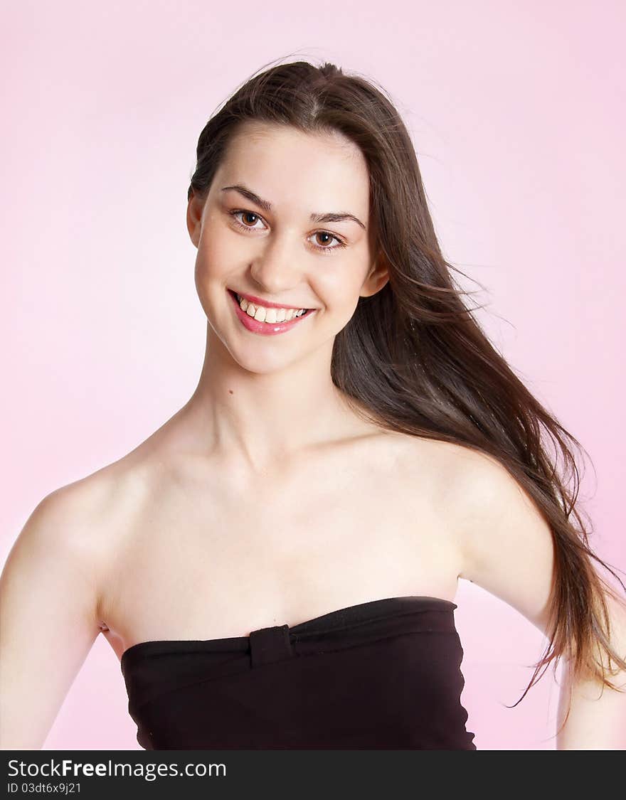 Portrait of a beautiful girl over pink background