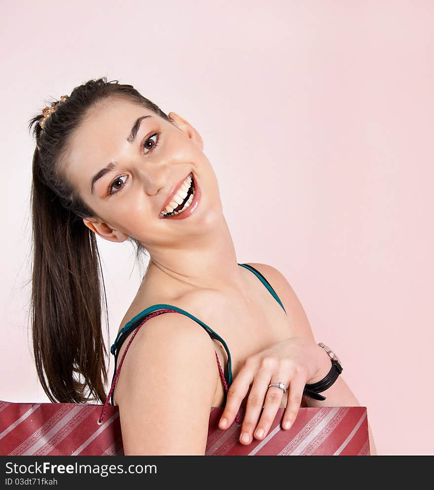 Portrait of a beautiful girl over pink background