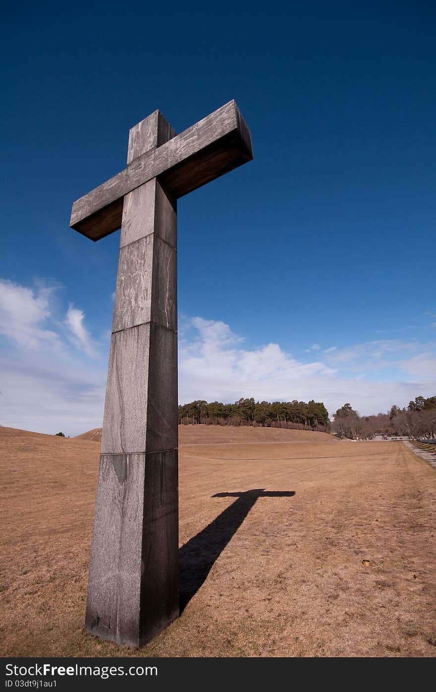 Christian cross on a field, with a nice blue sky