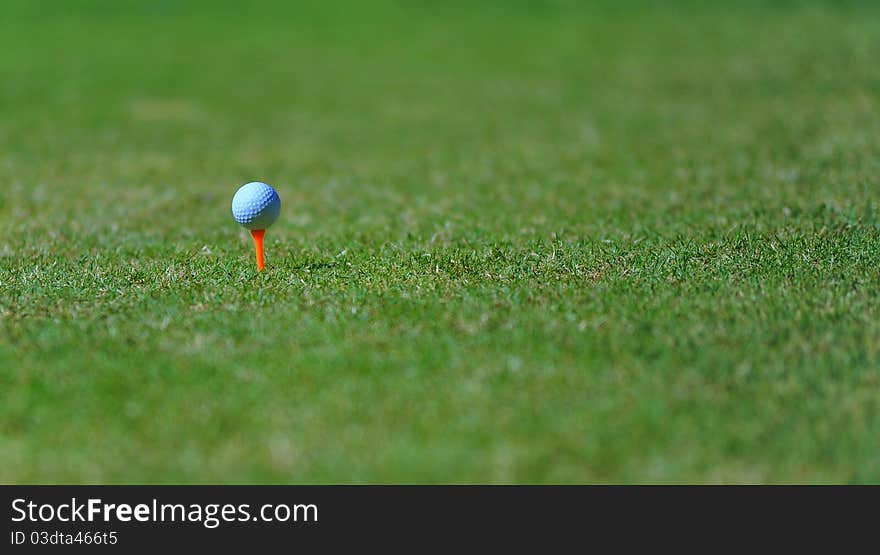 Golf ball sitting on tee ready to be hit. Golf ball sitting on tee ready to be hit