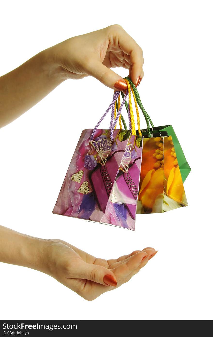 A girl holding shopping bags in hand, supports the second hand. A girl holding shopping bags in hand, supports the second hand