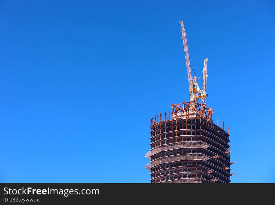 Construction. Two cranes on the top of the tower