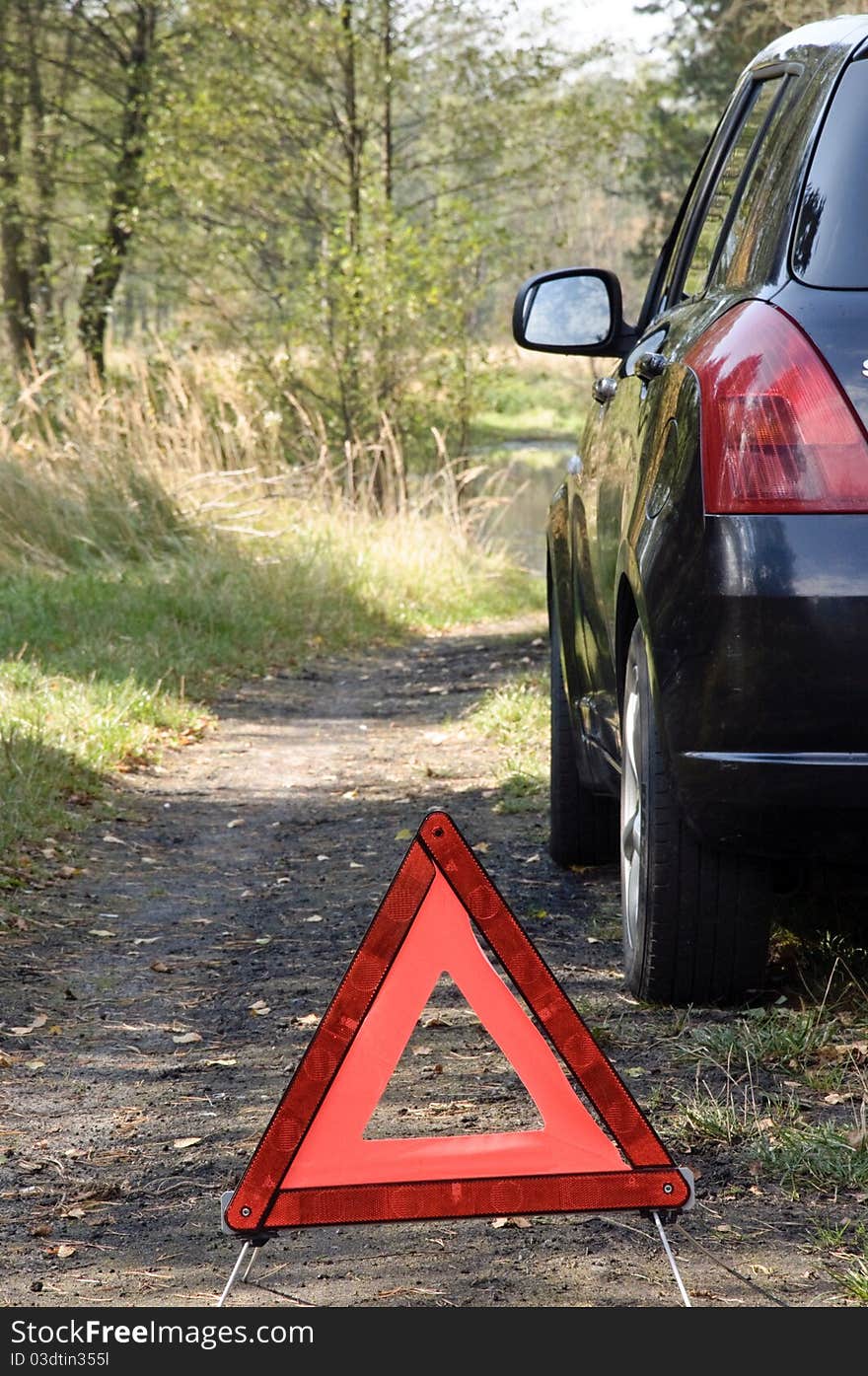 Car breakdown and red triangle.