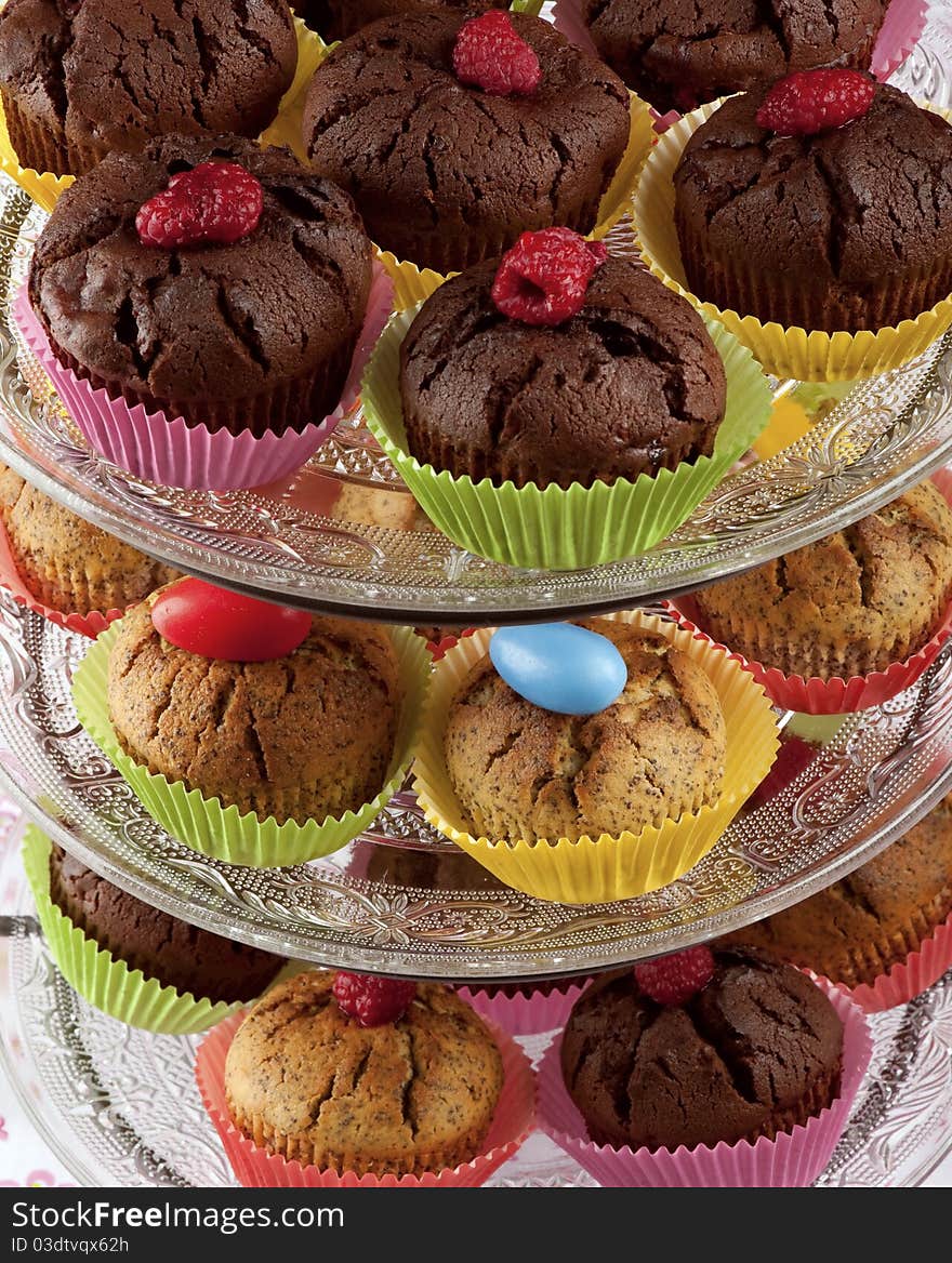 Chocolate and raspberry cupcakes on glass etagere