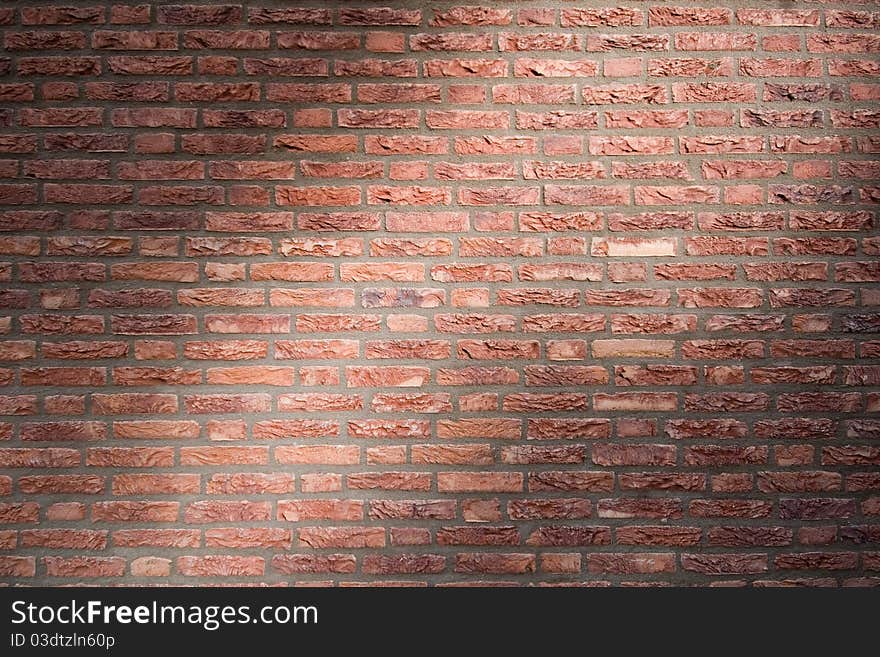 Brick wall with flush joints in dramatic lighting