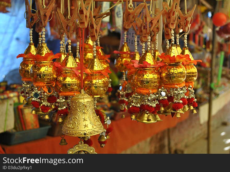 This is an image of Torans' which are used in Hindu culture for good luck and are usually hung in the houses and commercial establishments. This image was taken on a flea market close to a temple. This is an image of Torans' which are used in Hindu culture for good luck and are usually hung in the houses and commercial establishments. This image was taken on a flea market close to a temple.