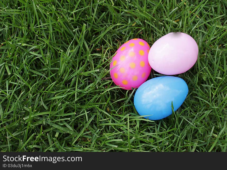 Easter eggs hidden in the grass for children to find on Easter. Easter eggs hidden in the grass for children to find on Easter.