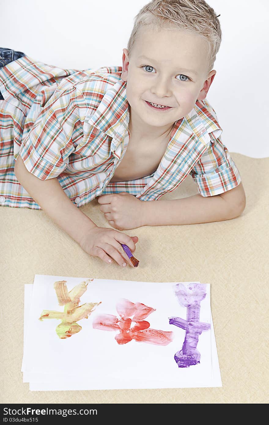 Boy painting his family with colorful paints