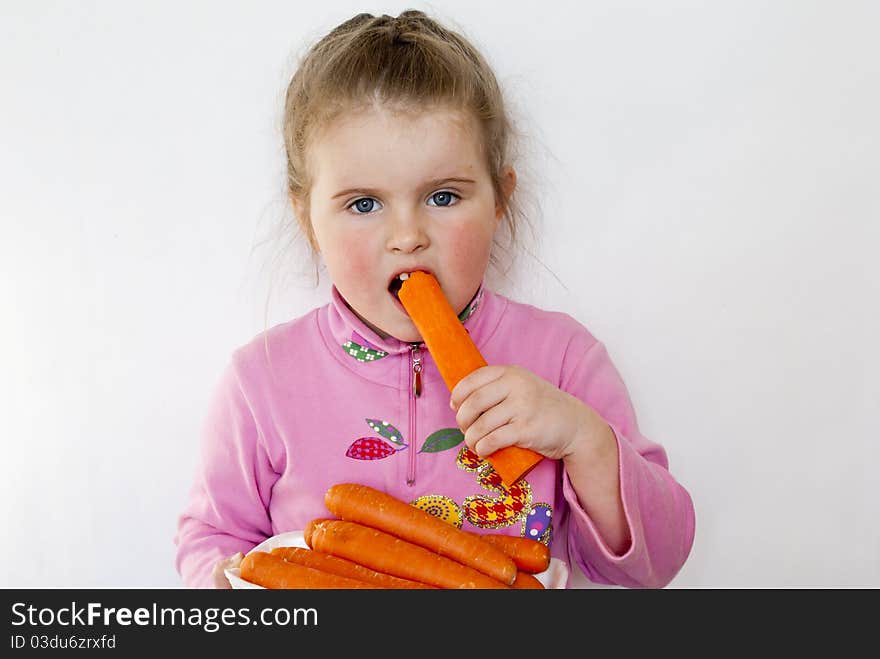 The girl eats carrots