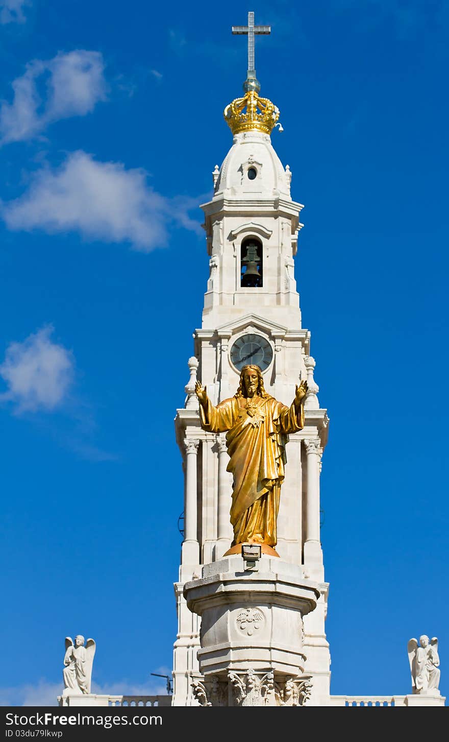 Statue of the Sacred Heart with the bell tower of Our Lady of the Rosary basilica behind. Statue of the Sacred Heart with the bell tower of Our Lady of the Rosary basilica behind