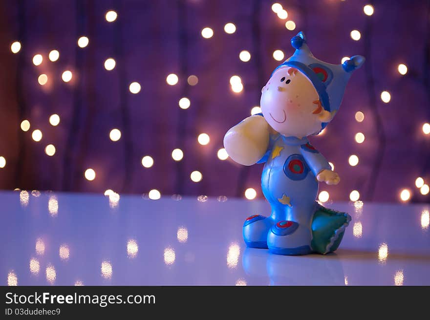 Baby doll goes to sleep in christmas light environment. Baby doll goes to sleep in christmas light environment