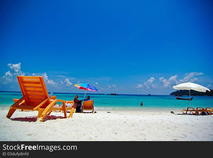 A longtail boat in Thai style is on a beach in Lipeh Island, Thailand. A longtail boat in Thai style is on a beach in Lipeh Island, Thailand