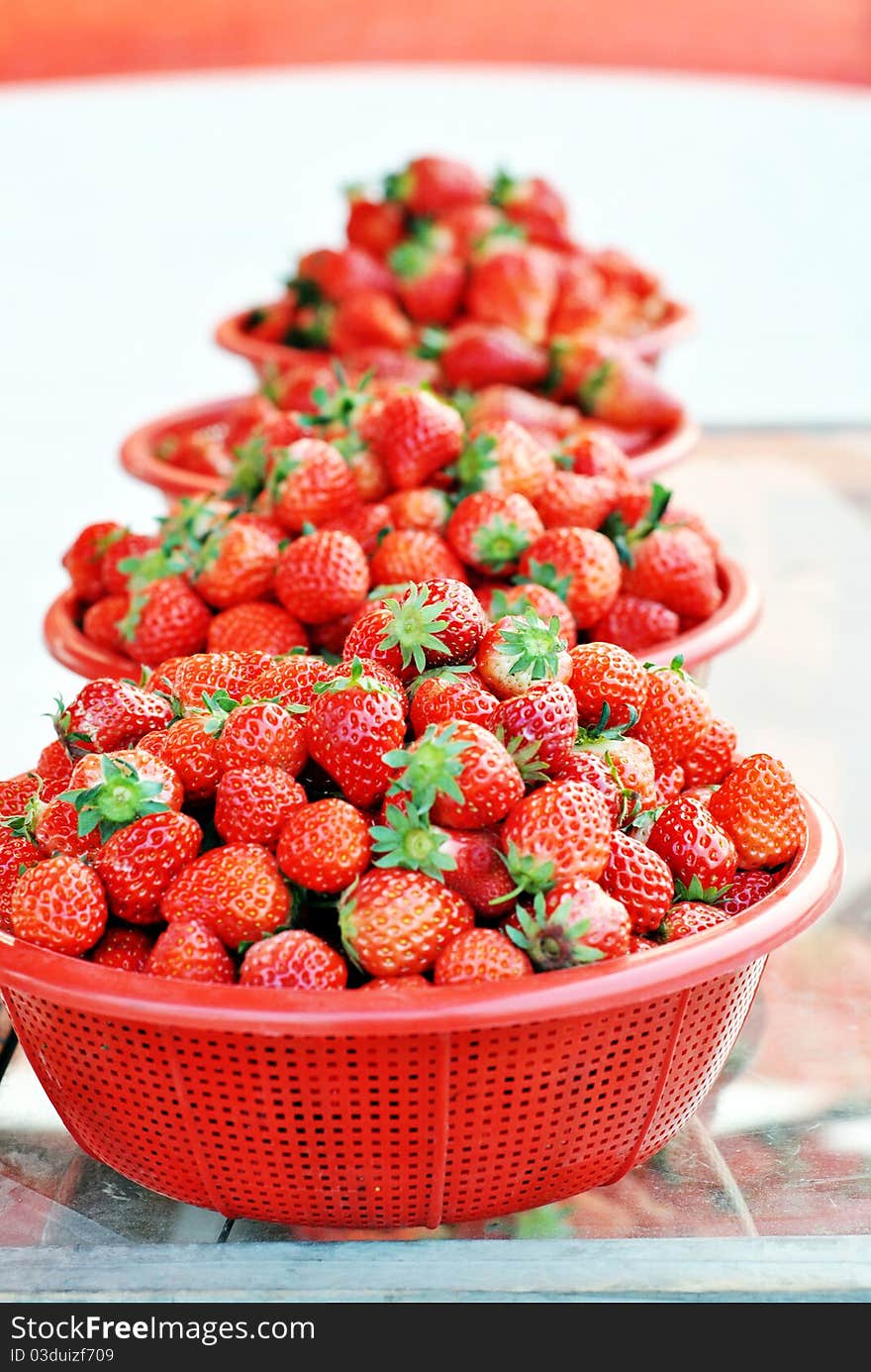 Strawberries with leaves in basketes