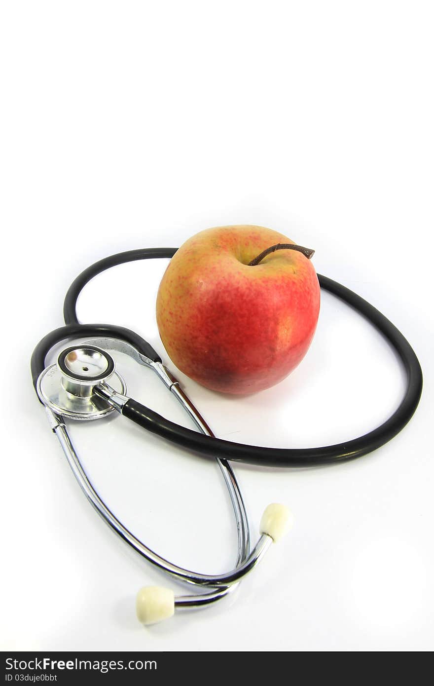 Apple and stethoscope on white background. Apple and stethoscope on white background