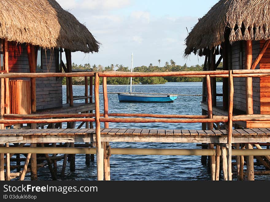 Beautiful hut in the water with a boat beside. Beautiful hut in the water with a boat beside