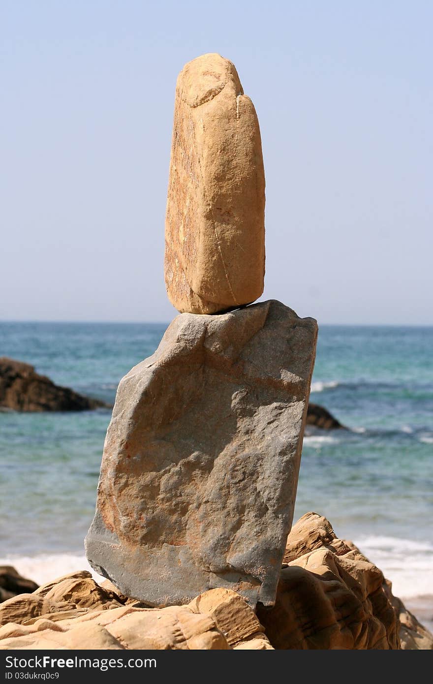 Beach with balanced rocks, by the sea