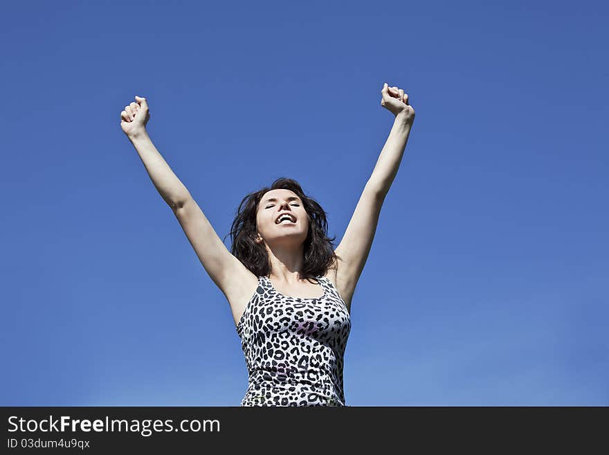 Woman with raised hands happy for her achievements. Woman with raised hands happy for her achievements