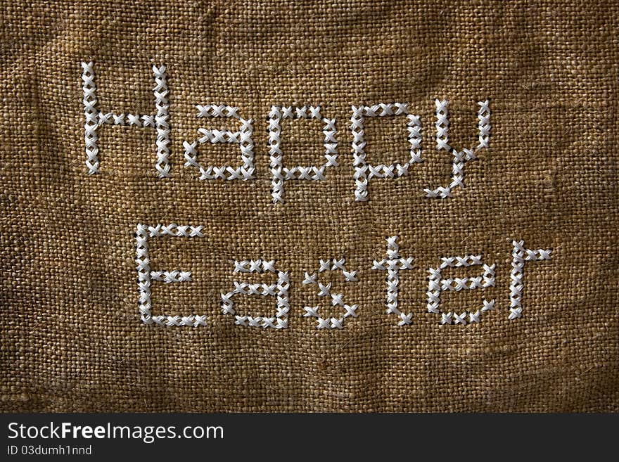 Words 'Happy Easter' embroidered on the old sack