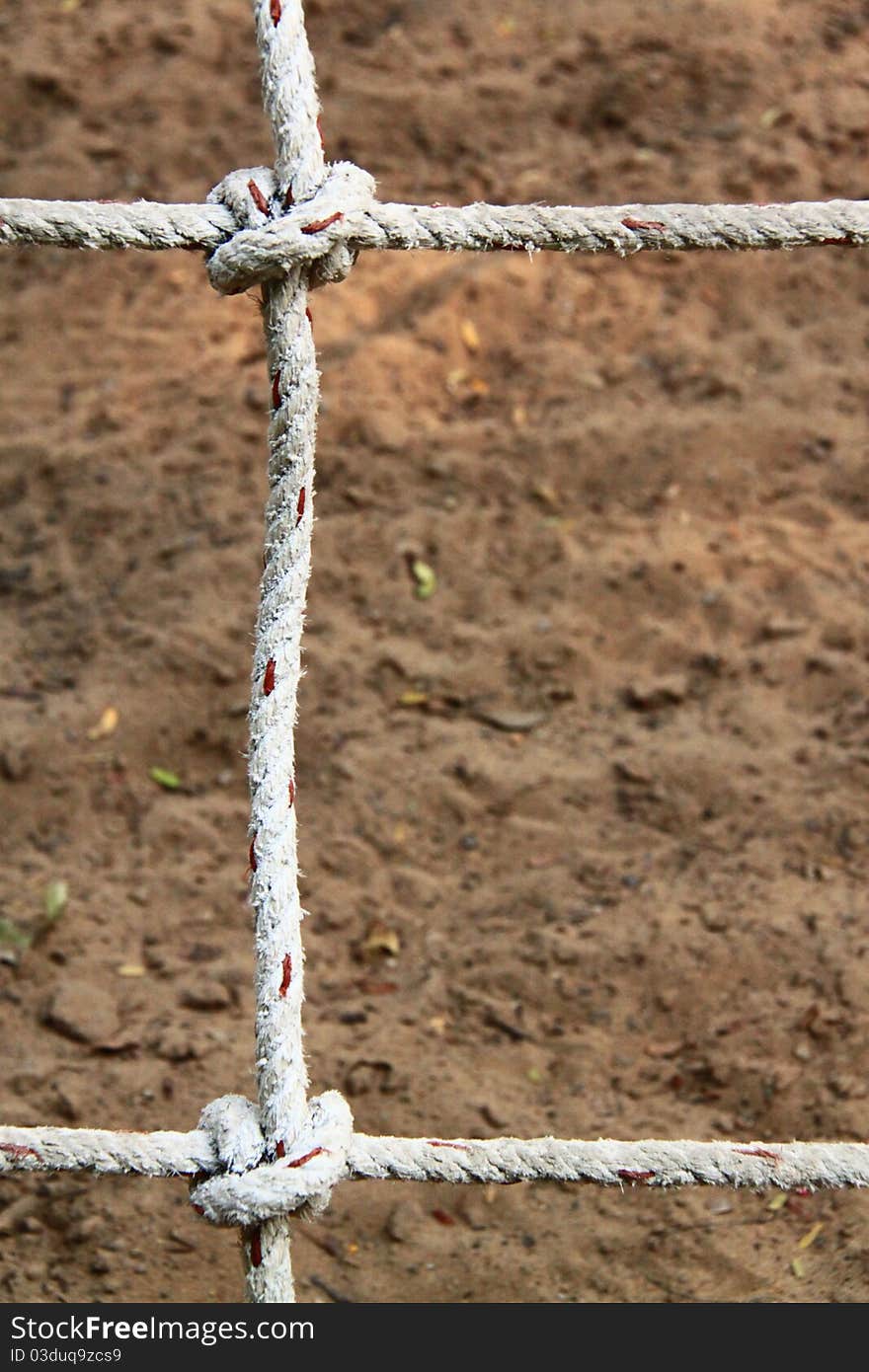 Rope with knots on the background of the sand