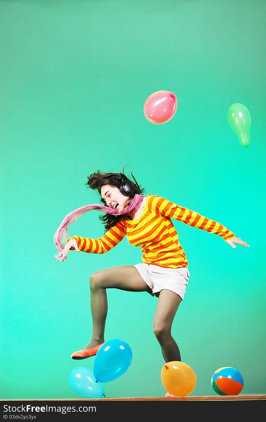 Jumping happy girl with balloons