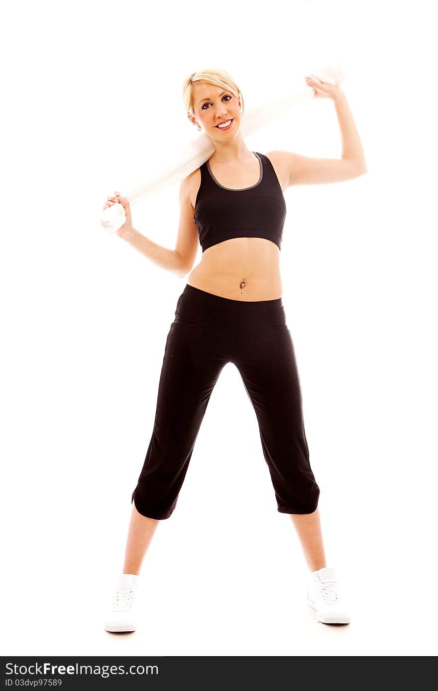 A young female dressed in black gym clothes holding a white towel. A young female dressed in black gym clothes holding a white towel