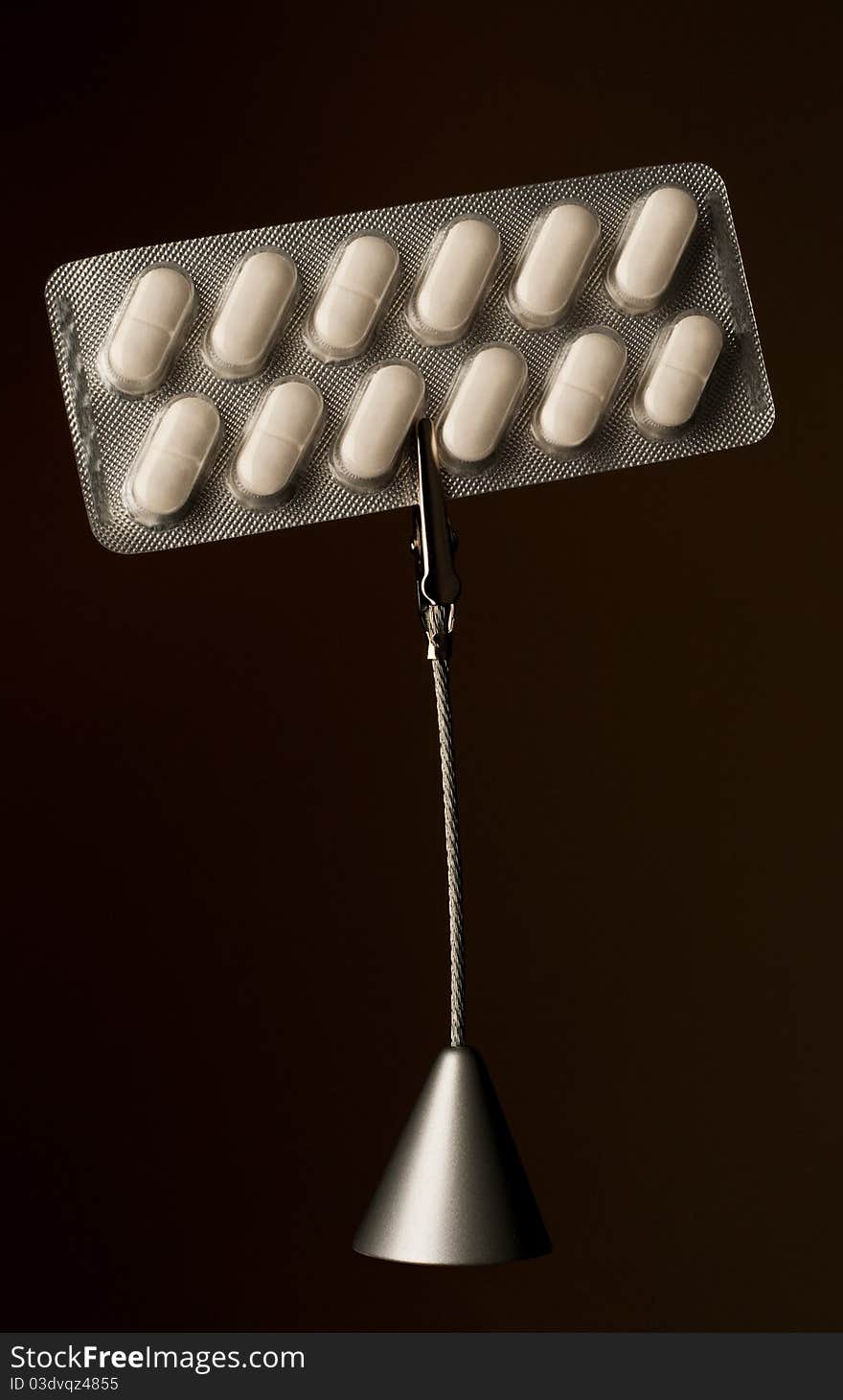 Memo holder with pills in blister on dark background. Memo holder with pills in blister on dark background