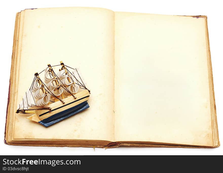 Old book and ship on white background