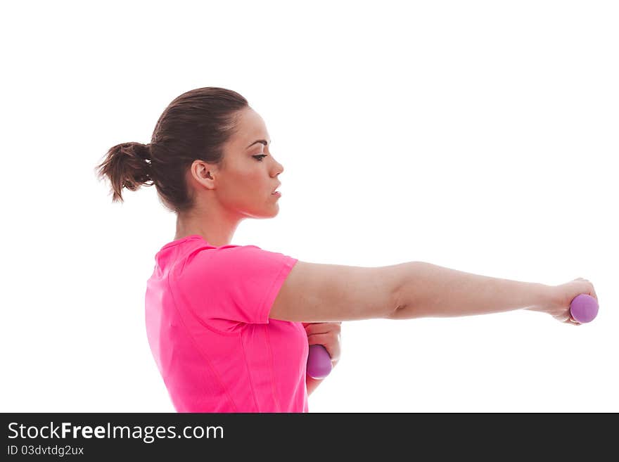 A young female in a pink top performing an exercise with weights. A young female in a pink top performing an exercise with weights