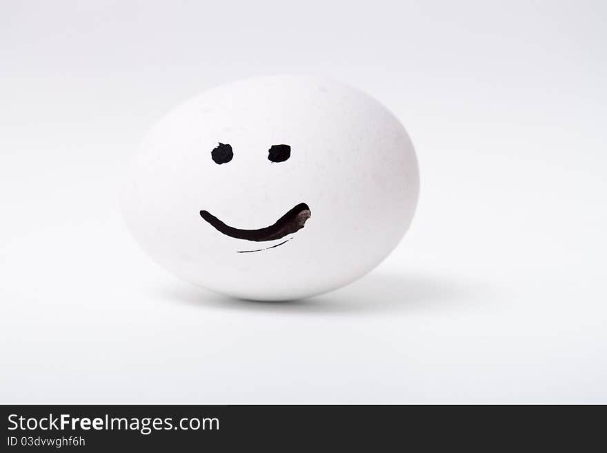 One white smiling egg