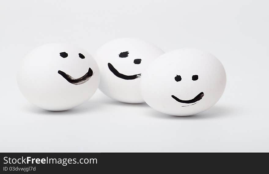 three white smiling egg