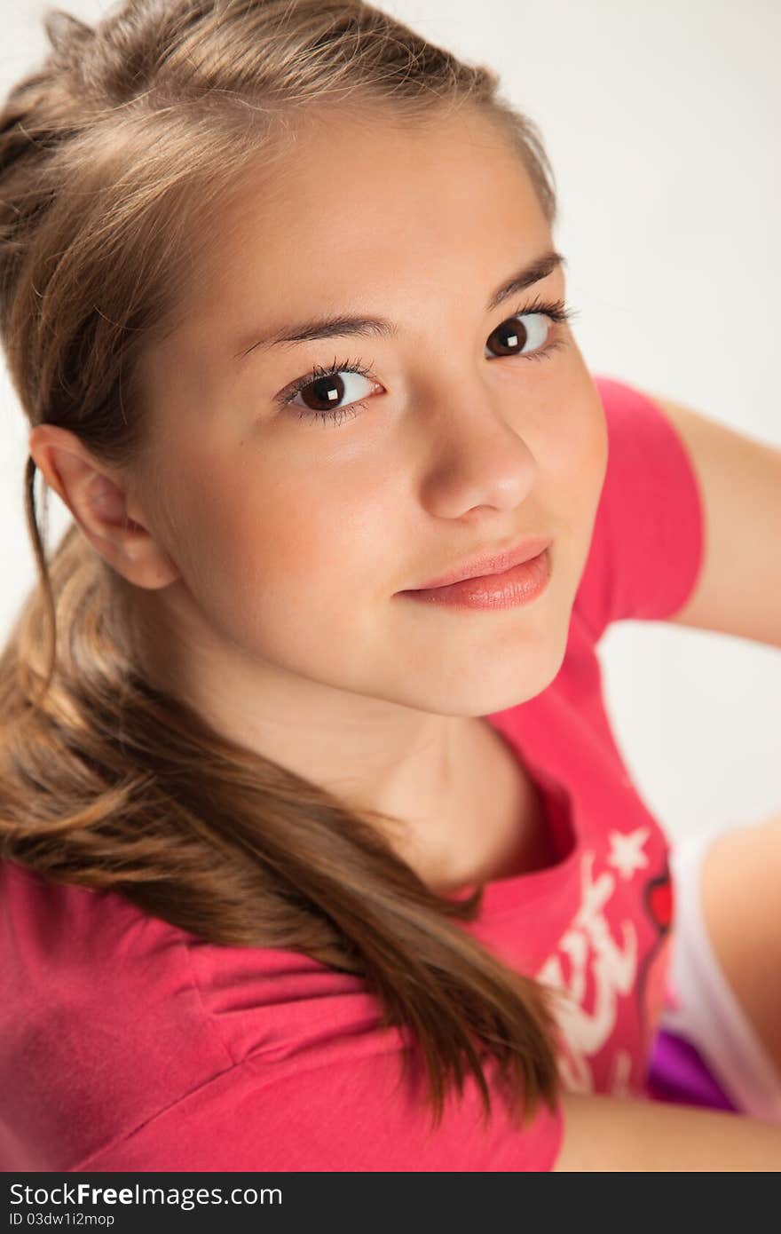 Beautiful Girl in pink Sitting looking up. Beautiful Girl in pink Sitting looking up.