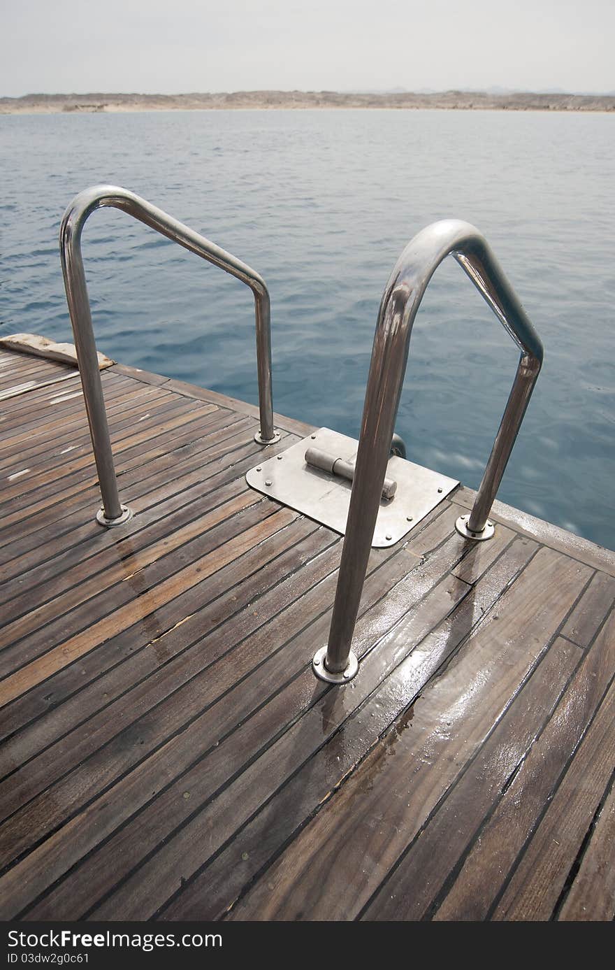 Metal ladder rails on the back deck of a boat. Metal ladder rails on the back deck of a boat