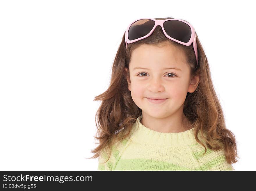 Young girl with sunglasses on head and wearing green striped jumper and smiling