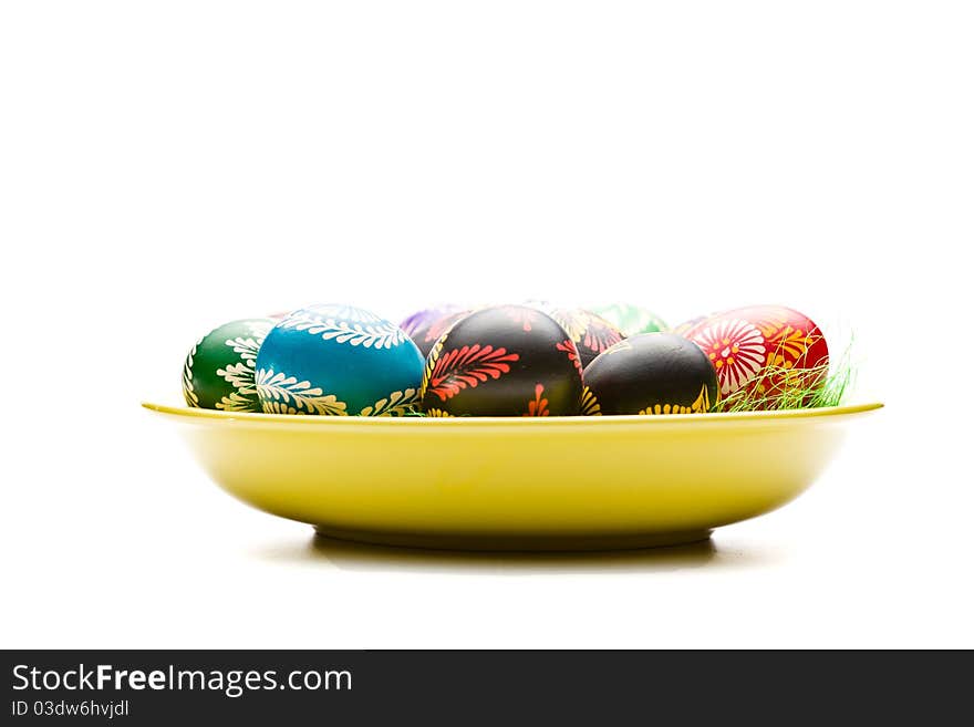 Painted Easter eggs on yellow plate. Painted Easter eggs on yellow plate