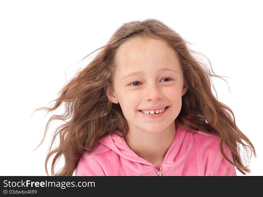 Young girl in pink top smiling with wind in her hair. Young girl in pink top smiling with wind in her hair