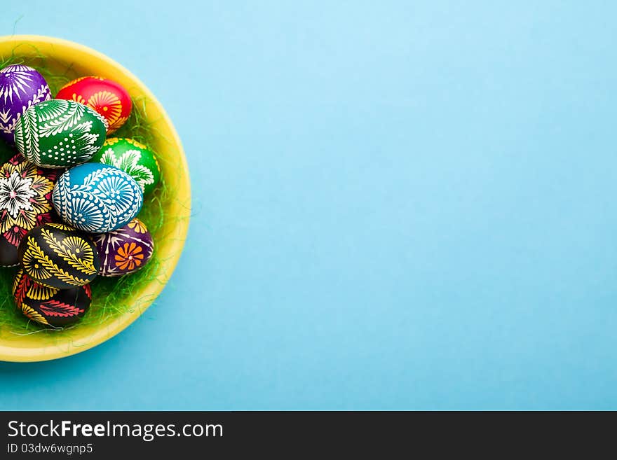 Painted Easter eggs on yellow plate. Painted Easter eggs on yellow plate