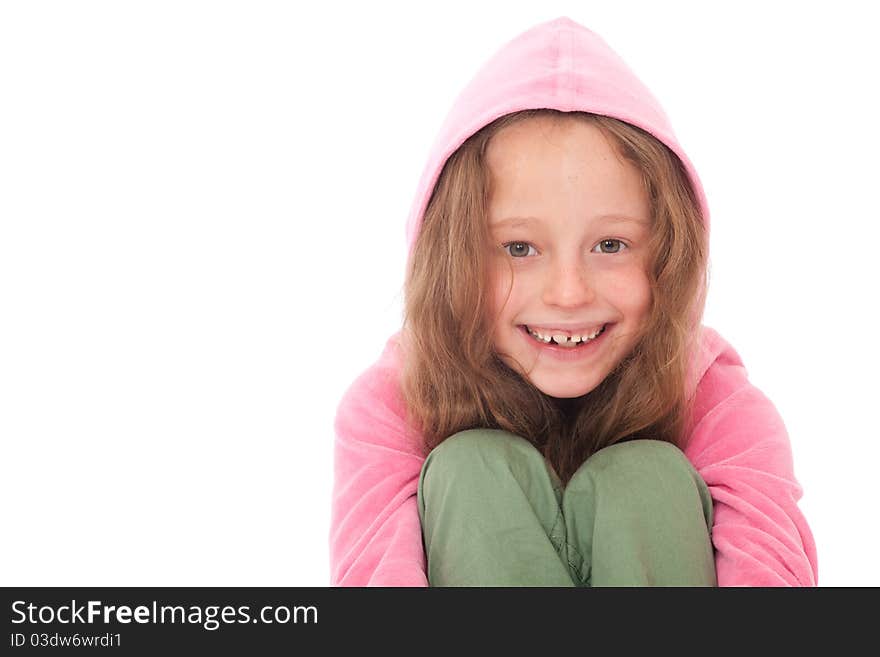 Young girl in pink hood top and green trousers smiling. Young girl in pink hood top and green trousers smiling