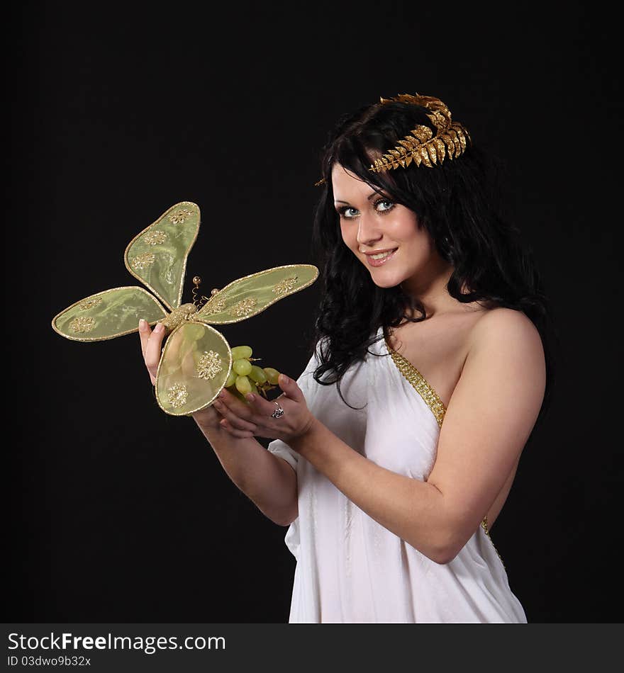 Woman with a bunch of grapes and a butterfly