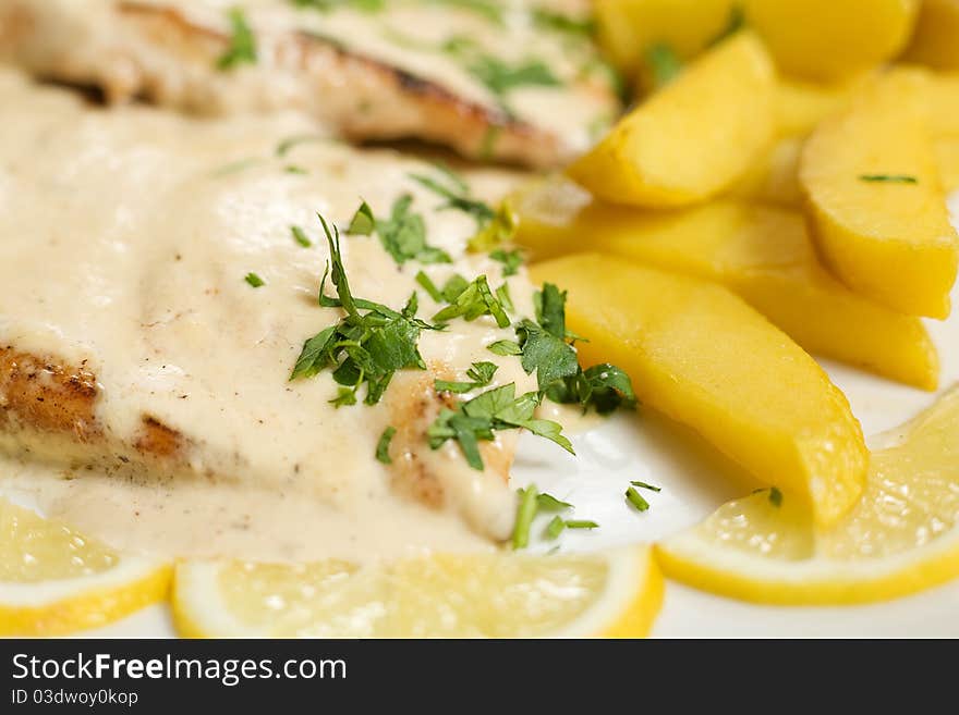 A plate of Chicken steak with sause, potatoes, close-up. A plate of Chicken steak with sause, potatoes, close-up