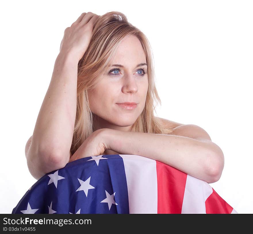 A cute girl poses with an American Flag. Her hand is in her hair. A cute girl poses with an American Flag. Her hand is in her hair.