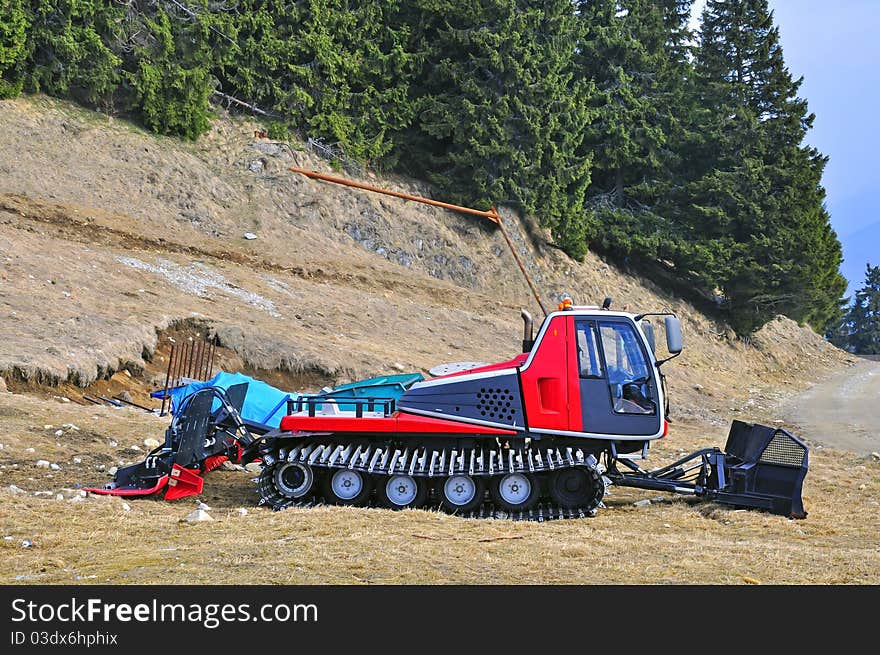 Mountain excavator for removing the snow on the ski trace. Mountain excavator for removing the snow on the ski trace