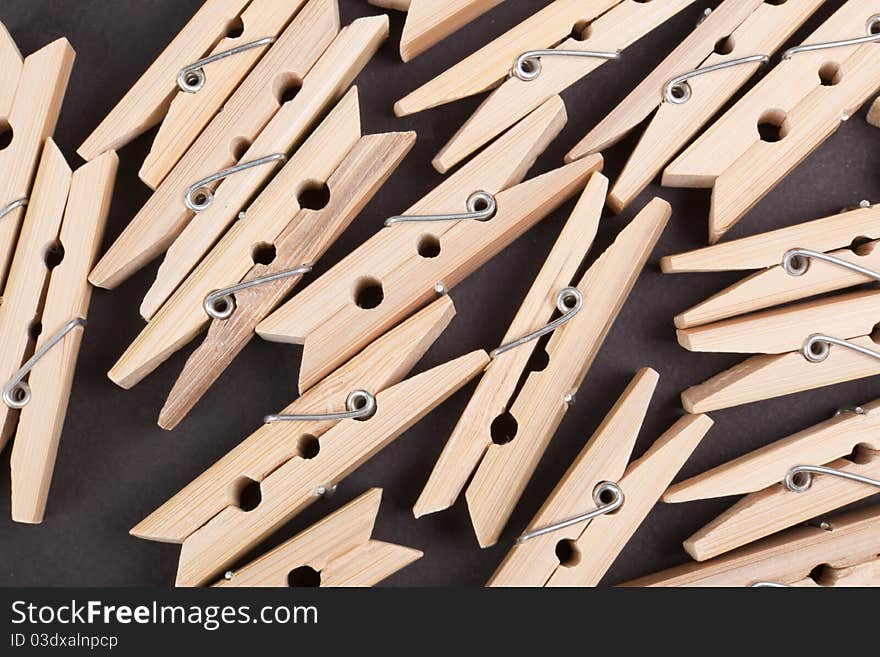 Wooden clothespins on a black background