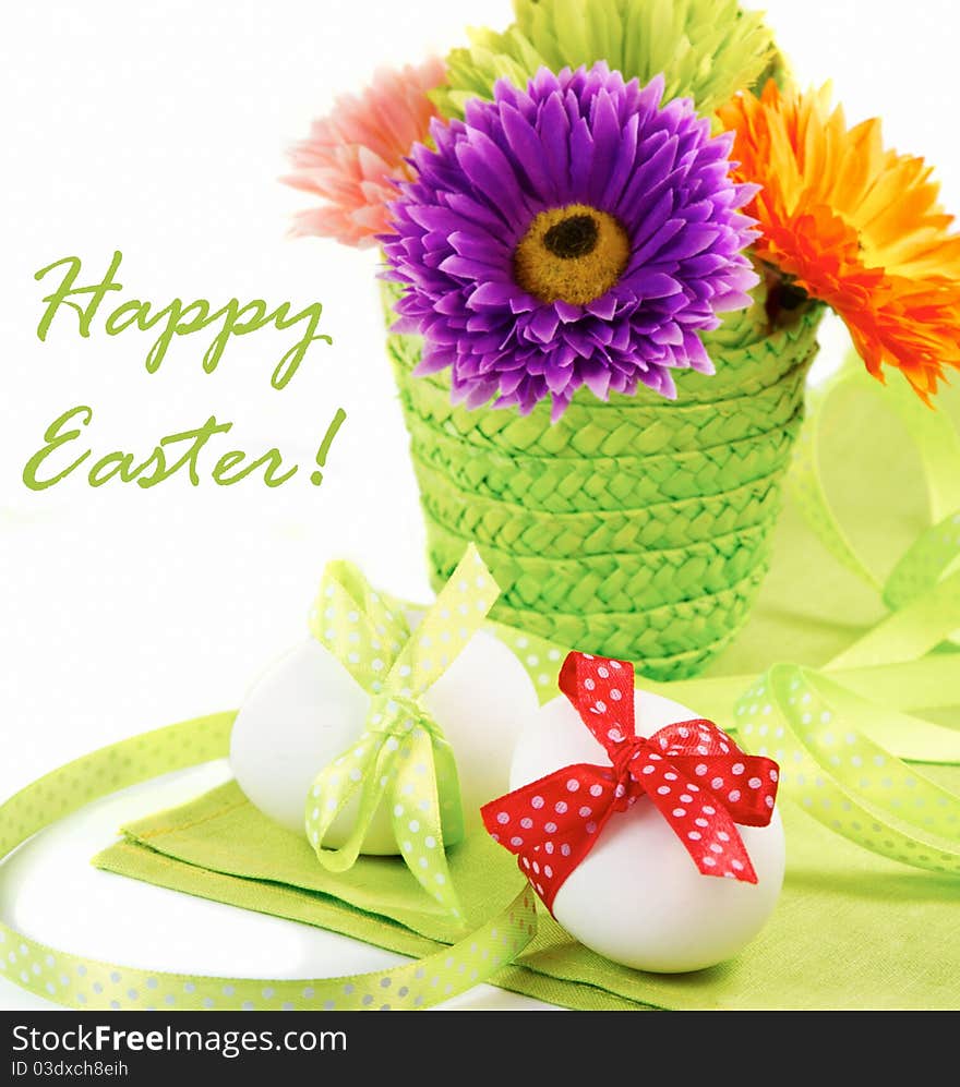 Easter still-life. Decorated eggs and a basket of flowers