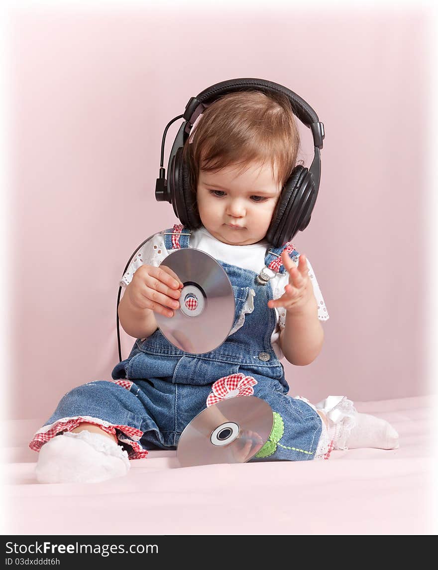 Child with CD discs in ear-phones