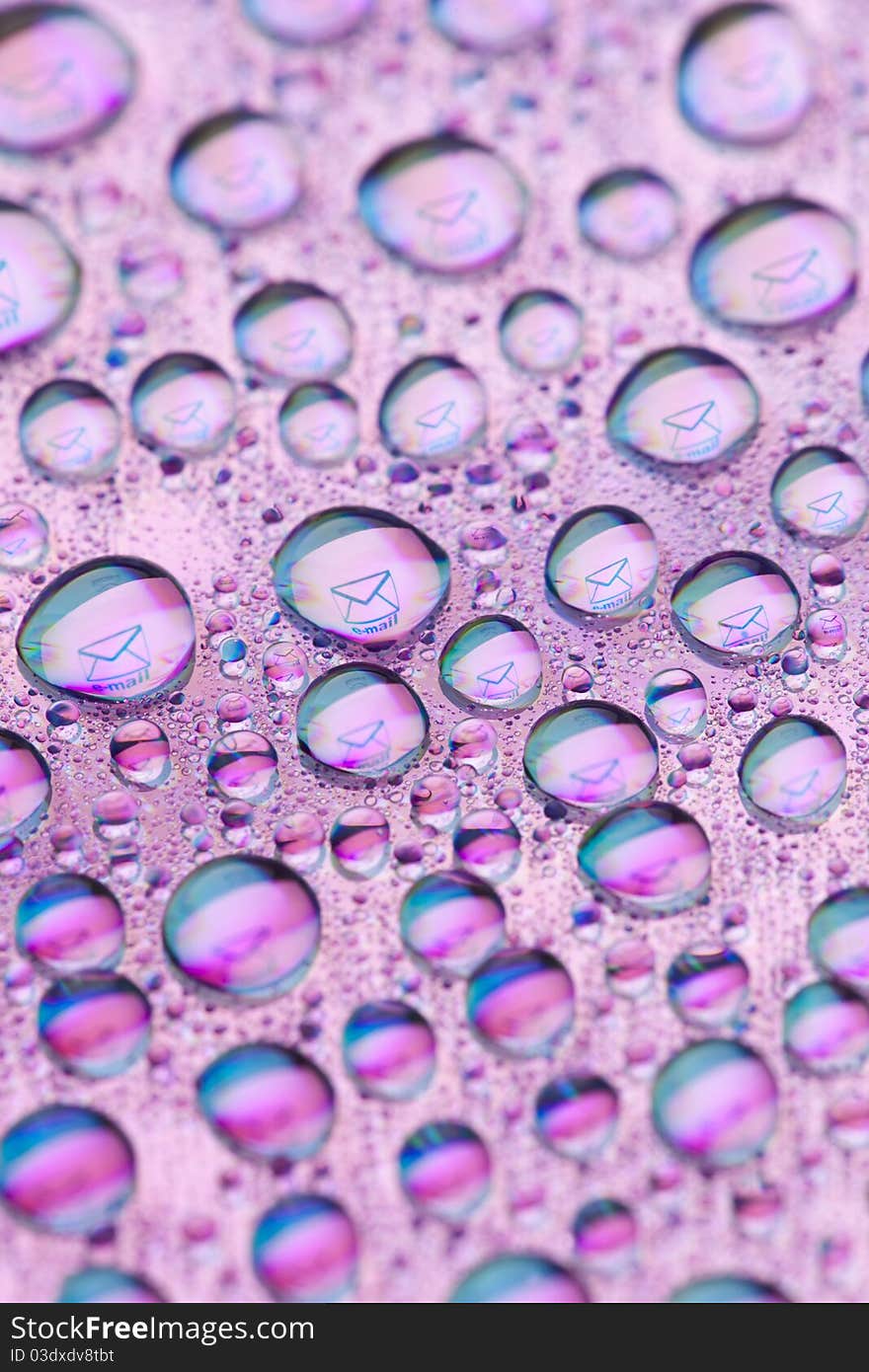 Envelope symbol reflected in the drops of water. Close-up of water droplets placed on a DVD disc. Envelope symbol reflected in the drops of water. Close-up of water droplets placed on a DVD disc.